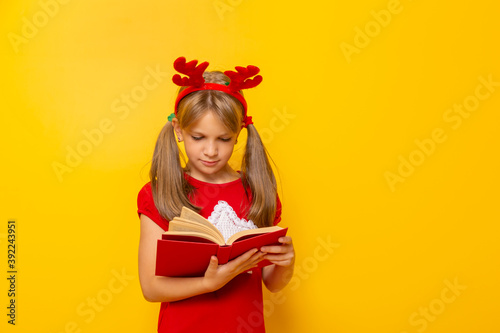 Little girl reading Christmas stories