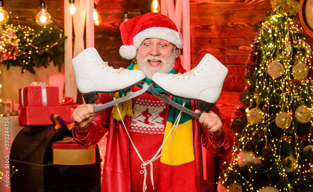 Bearded man with pair of skates. Skater christmas gift. Winter fun christmas holidays. Winter sports. Winter leisure. Elderly people fun. Be active. Santa Claus grandfather hold figure skates