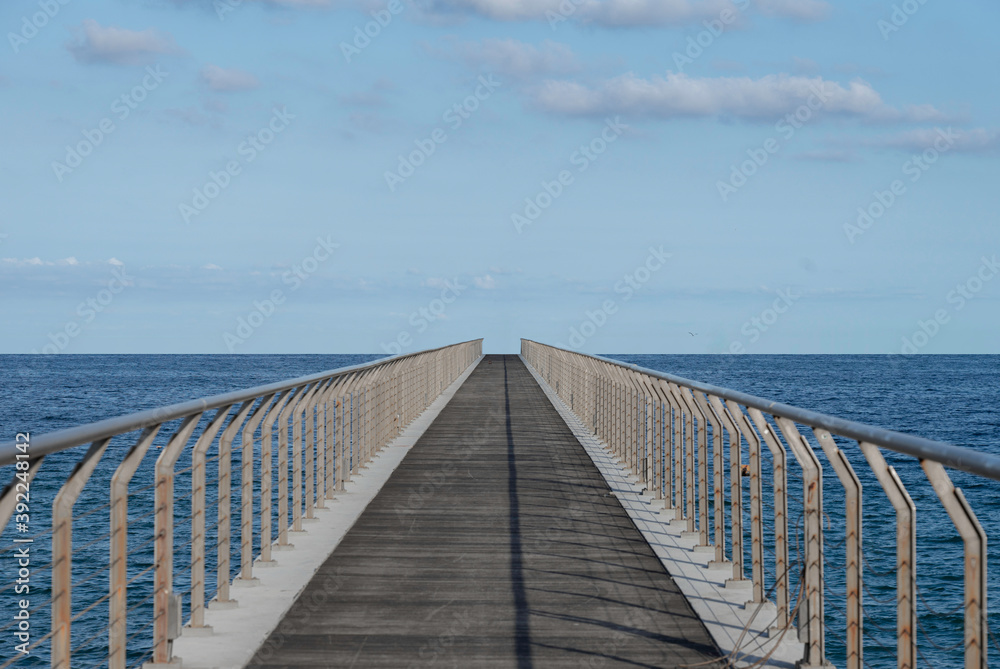 Infinite walkway aligned to the horizon in the middle of the sea