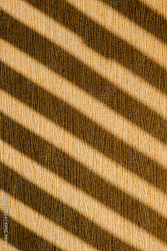 Brown wallpaper background with diagonal graphical silhouette stripes lines sun light and shade from a window. Abstract wall shadows pattern background. Interior design.