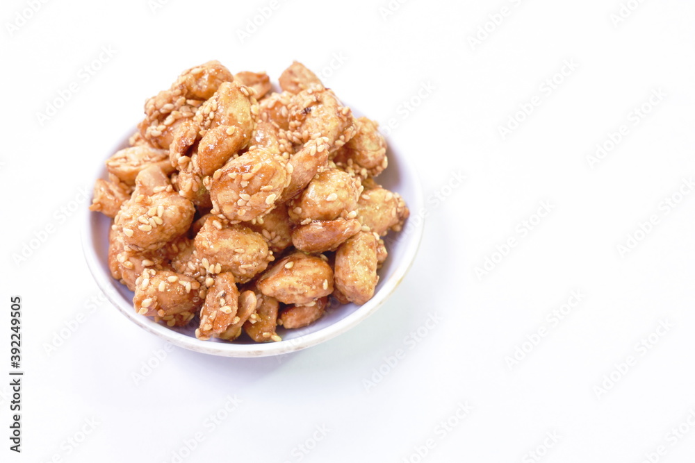 crispy sweet peanut coating syrup and dressing sesame on white background crispy sweet peanut coating syrup and dressing sesame on white background