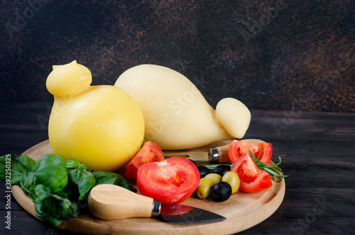 Traditional italian cheese Caciocavallo, homemade cheesy Pasta filata with vegetables photo