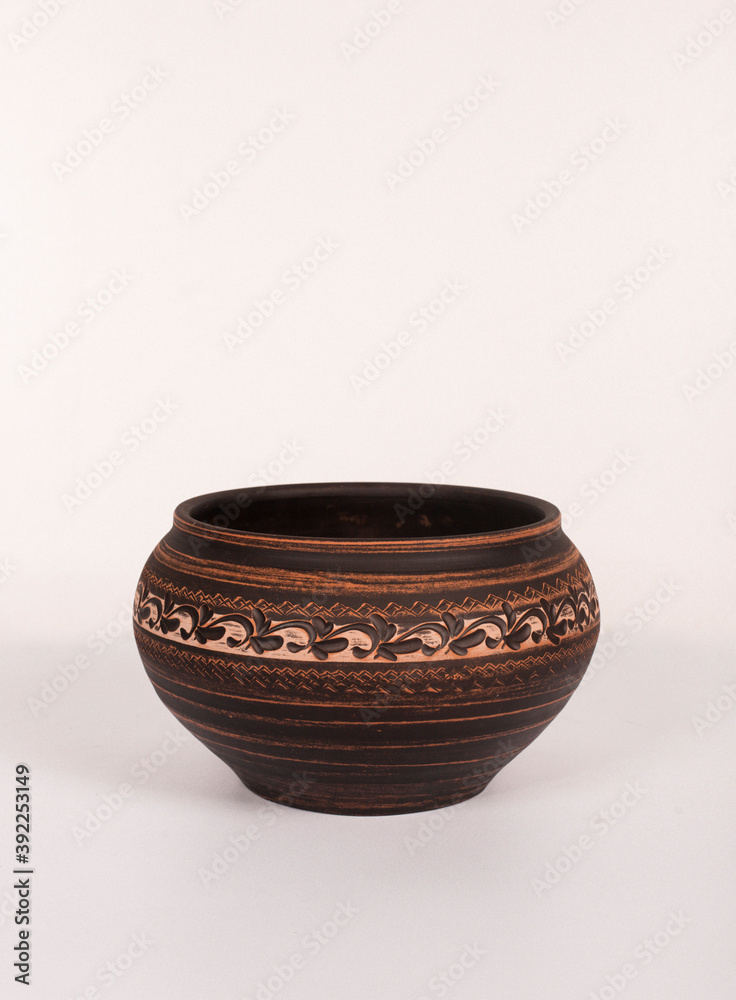 Ceramic ware isolated on a white background. Single rustic clay bowl. Ceramic ware isolated on a white background. Single rustic clay bowl.
