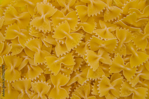 Dry pasta background.Macaroni products are scattered as a background and texture.