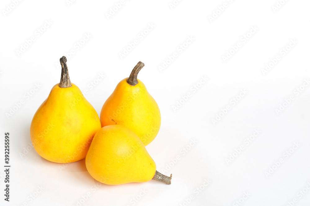 Three orange pumpkins in the shape of a pear on a white background. Autumn pumpkin harvest Three orange pumpkins in the shape of a pear on a white background. Autumn pumpkin harvest