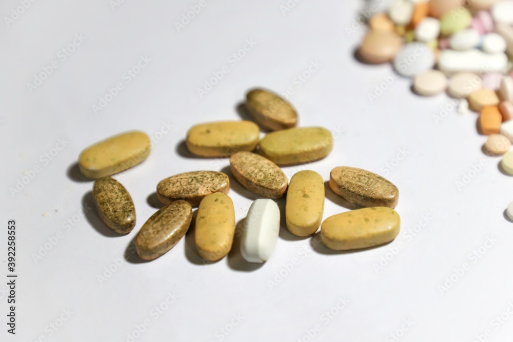 Expired ,rotten brown pills on a white background Expired ,rotten brown pills on a white background