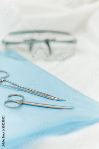 selective focus medical instrument lying on on on the blue sterilized blue wrap in hospital. Surgery  medical technology  health care cancer  disease treatment concept