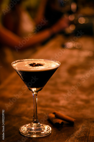 espresso martini cocktail drink in cozy dark bar interior