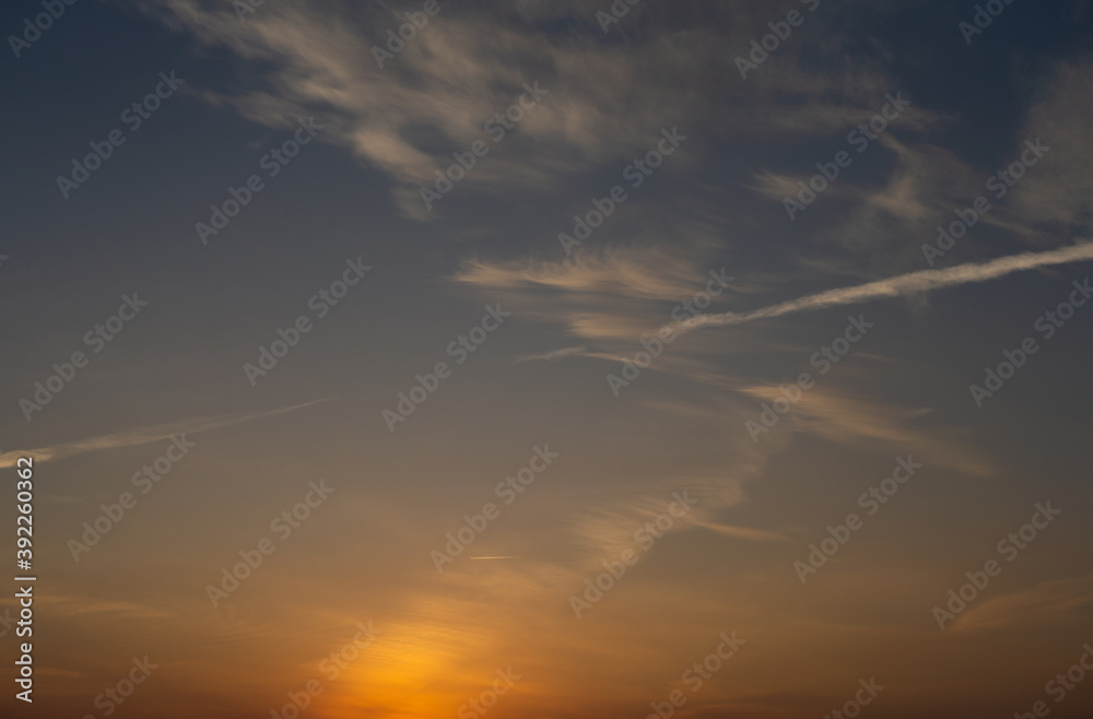 Dawn sky with clouds and contrails