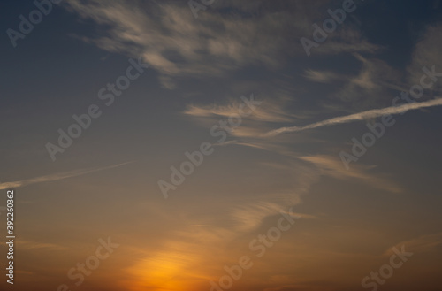 Dawn sky with clouds and contrails © Bert Folsom