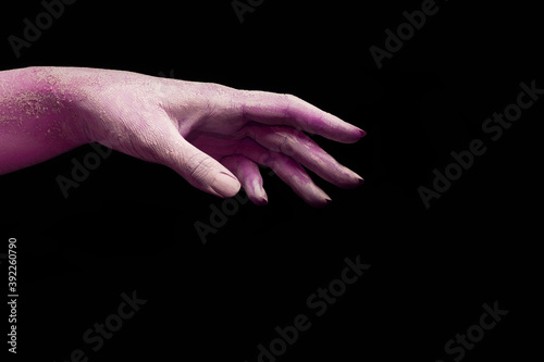 A beautiful horror purple female hand stretches your product on a black isolated background, concept art 