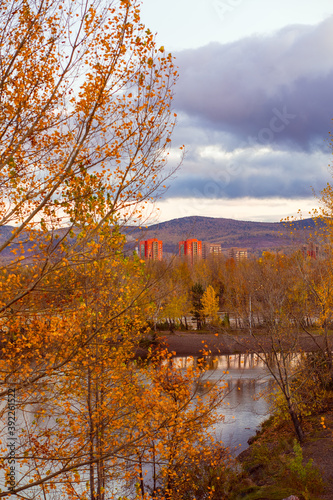 Golden autumn in the city, on the banks of the river.