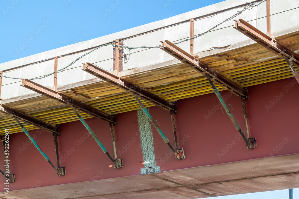 close-up view of road bridge under construction. connection of steel powerful straight crossbar, bridge connection, metal architecture. close-up view of road bridge under construction. connection of steel powerful straight crossbar, bridge connection, metal architecture.