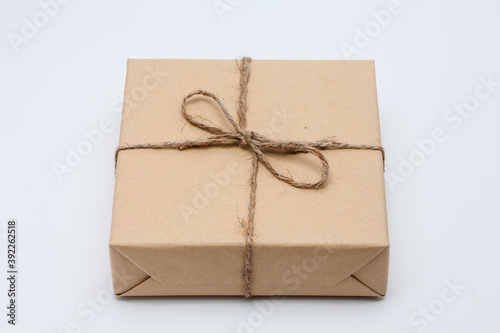 Brown parcel Kraft gift box present on white background