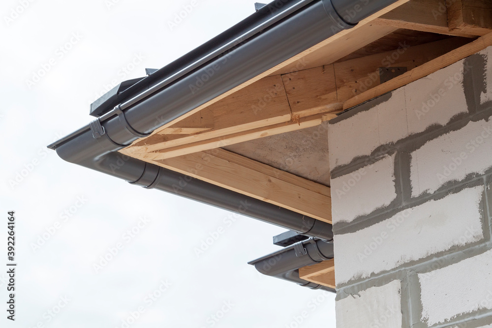 Fototapeta premium close up view of house under construction with holders for gutters water drainage system