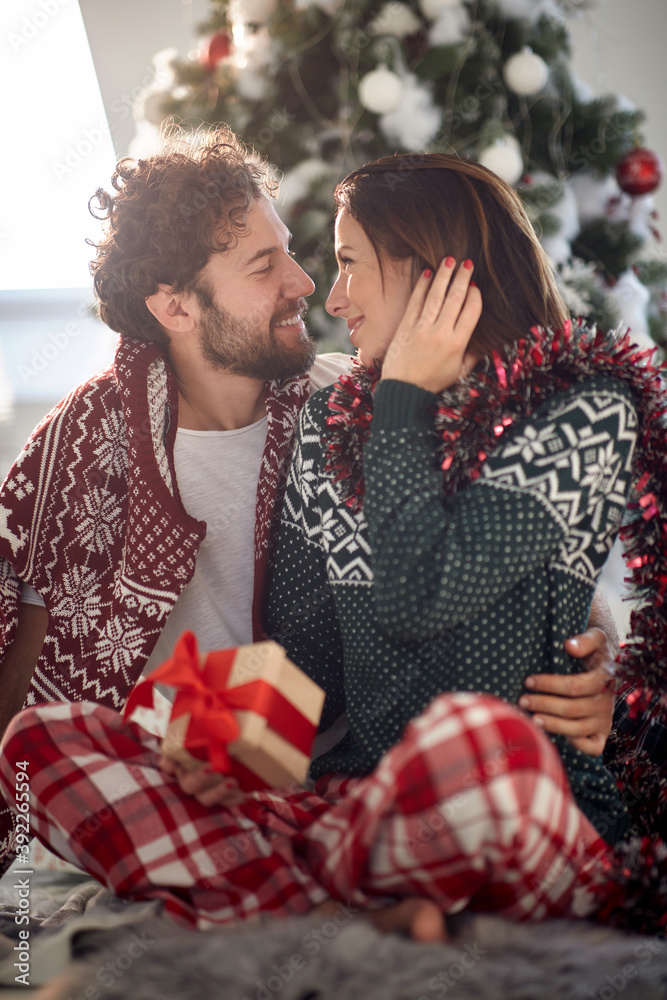 Cheerful couple sharing gifts on Chrismas morning Cheerful couple sharing gifts on Chrismas morning