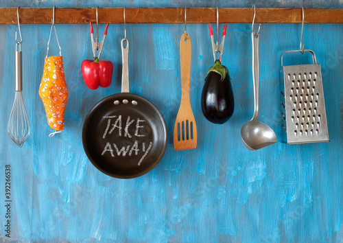 Restaurant offering take away food during corona virus lockdown, kitchen utensils and message, gastronomy shutdown concept, good copy space photo