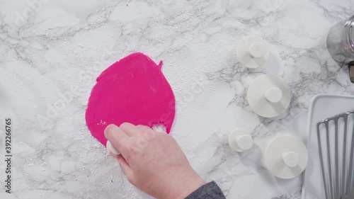 Flat lay. Step by step. Rolling our pink fondant on a marble counter.