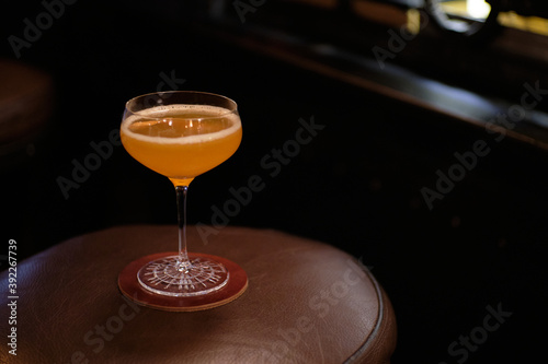 Brown Derby cocktail, grapefruit peel on leather background photo