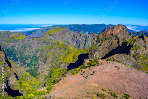 Beautiful hiking trail from Pico do Arieiro to Pico Ruivo, Madeira island. Footpath PR1 - Vereda do Areeiro. On summy summer day above the clouds. Portugal. © Simon Dannhauer