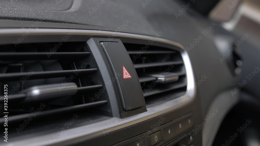 Pressing Car Hazard Emergency Lights Button Close Up