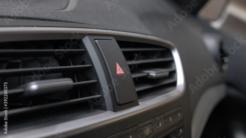 Pressing Car Hazard Emergency Lights Button Close Up © maradek