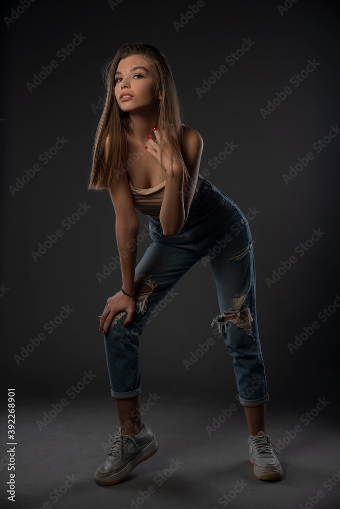 Portrait of beautiful girl posing in studio on grey background. Isolated Portrait of beautiful girl posing in studio on grey background. Isolated