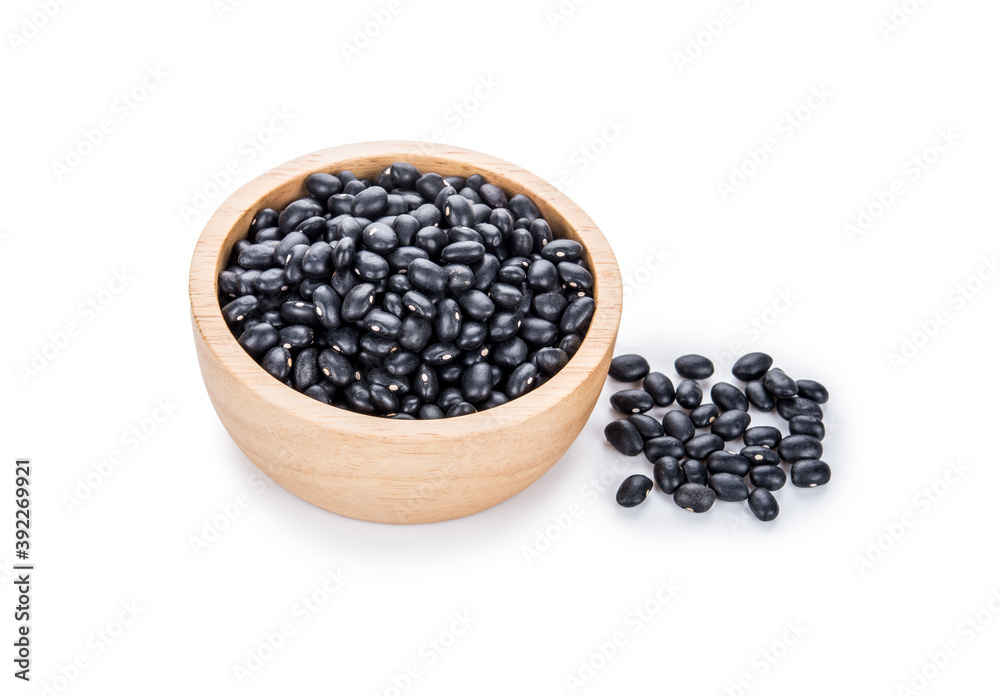 Black beans in a wooden bowl on white. Black beans in a wooden bowl on white.