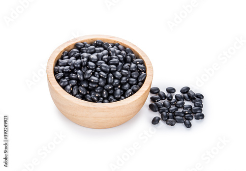 Black beans in a wooden bowl on white.