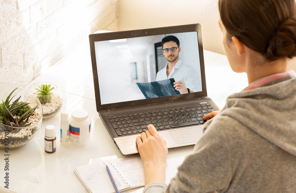 Woman sitting at home during an online consultation with her general practitioner. Medical technology, video chat with a doctor Woman sitting at home during an online consultation with her general practitioner. Medical technology, video chat with a doctor