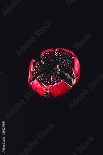 juicy pomegranate on black background