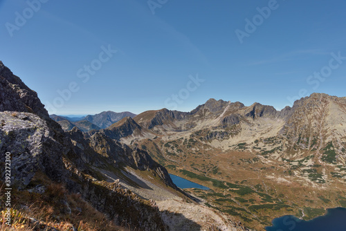 Landscapes with a tourist on a background of mountains and lakes with evening lighting