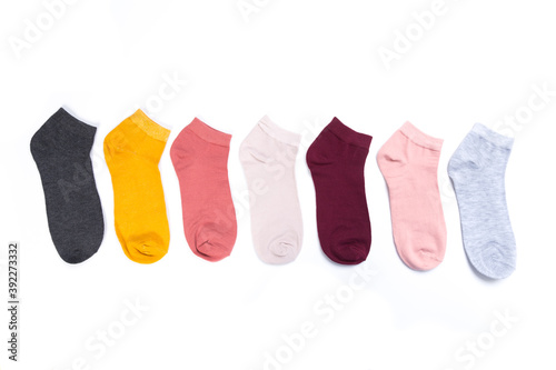 several colored new short socks on a white background, top view
