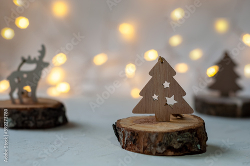 Wooden Christmas tree with bokeh on a white background.The mood of Christmas.
