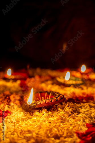 Photography Flower petal rangoli for Diwali with diwali diya selective focus