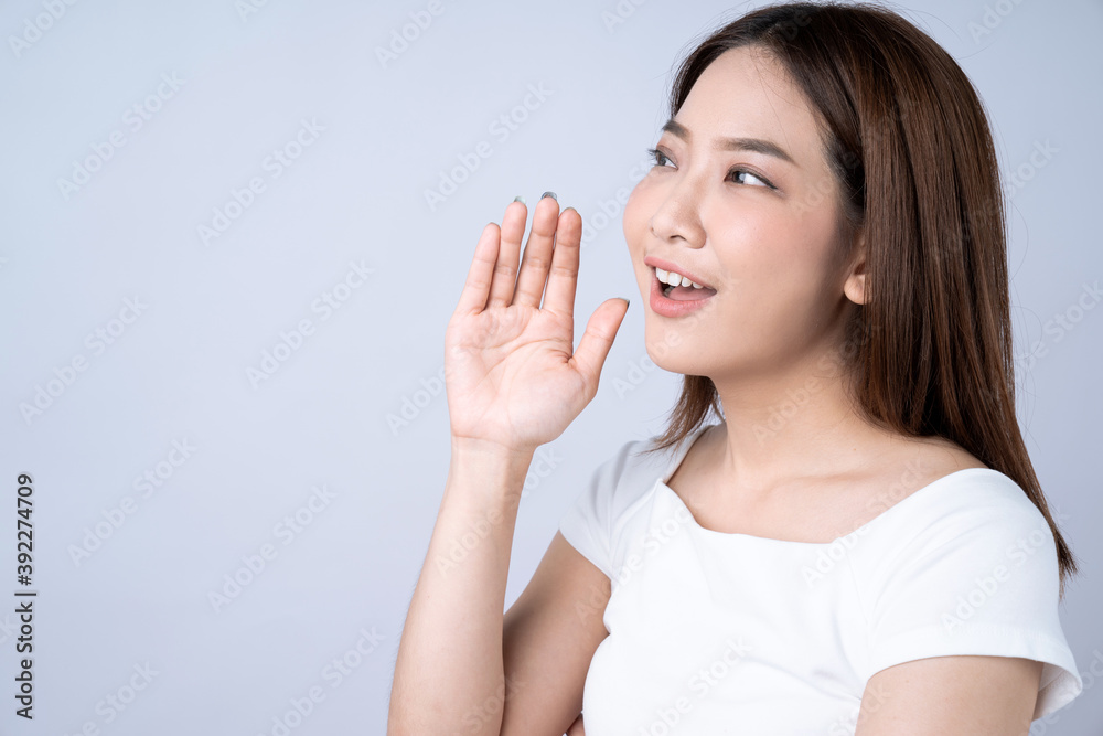 Beautiful Asian woman cupped her mouth and whispered a secret, isolated on white background. Beautiful Asian woman cupped her mouth and whispered a secret, isolated on white background.