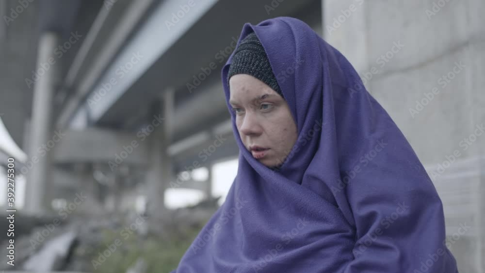 Homeless woman talking, sitting outdoor, mental health, person with disabilities Homeless woman talking, sitting outdoor, mental health, person with disabilities