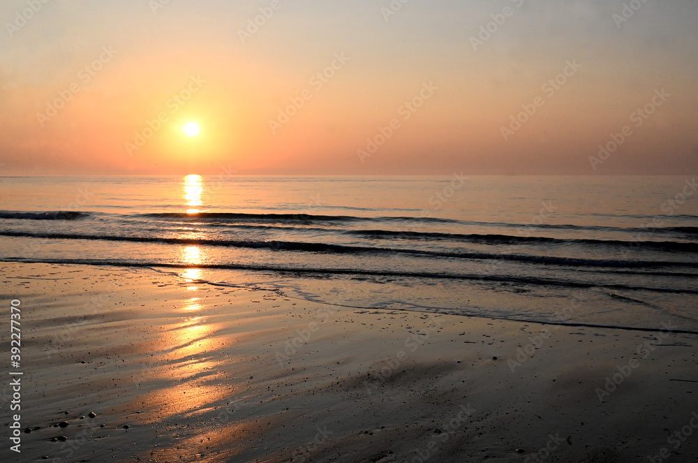 Sunrise over calm sea on the east coast of England, Walberswick, Suffolk Sunrise over calm sea on the east coast of England, Walberswick, Suffolk