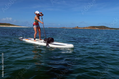 Paddle boarder crossing from Bryher to St. Mary's, Isles of Scilly photo