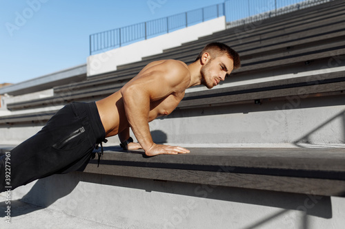 sporty shirtless man doing push-ups outdoors, focused athlete doing exercises outdoors, sport, motivation