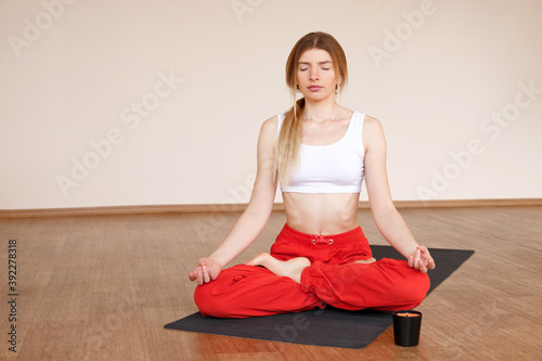 Girl meditates in yoga class in the studio © Екатерина Арцыбашева