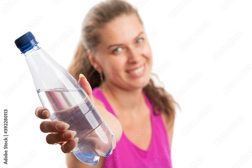 Close-up of water bottle presented by fit woman selective focus Close-up of water bottle presented by fit woman selective focus