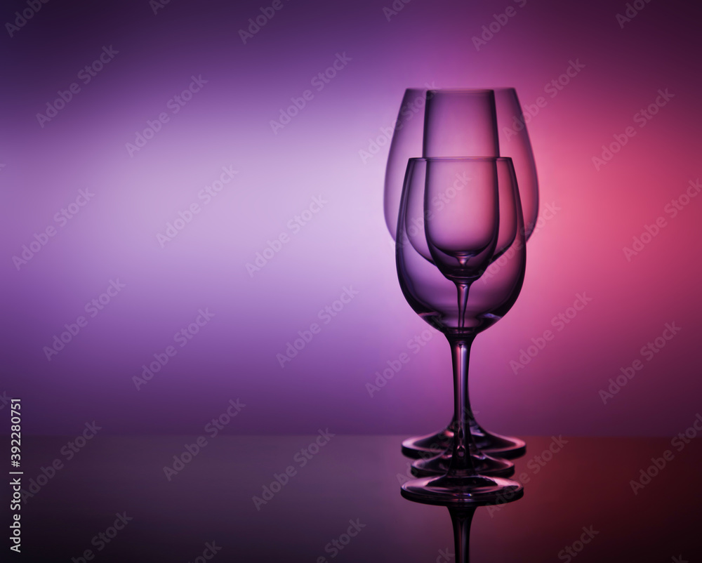 close-Up view Of various empty Glasses Against Colored Background close-Up view Of various empty Glasses Against Colored Background