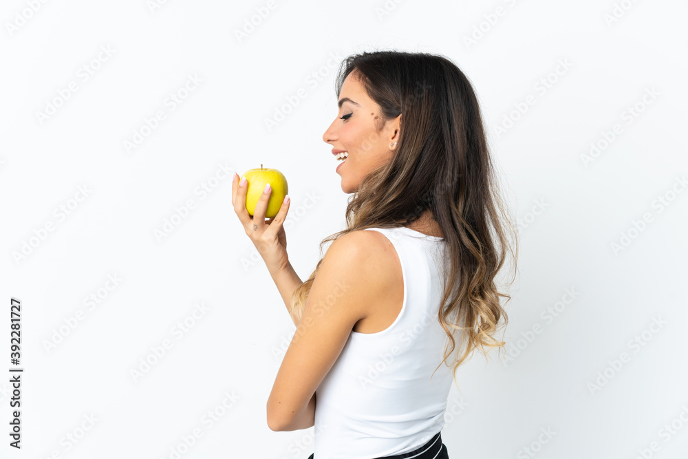 Young caucasian woman isolated on white background eating an apple Young caucasian woman isolated on white background eating an apple