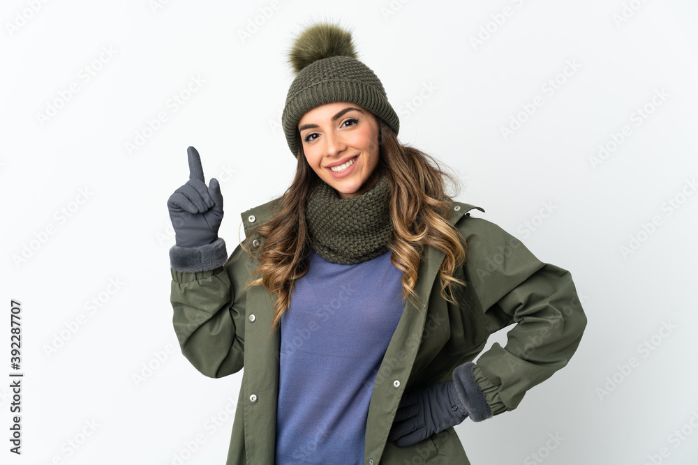 Young girl with winter hat isolated on white background showing and lifting a finger in sign of the best Young girl with winter hat isolated on white background showing and lifting a finger in sign of the best