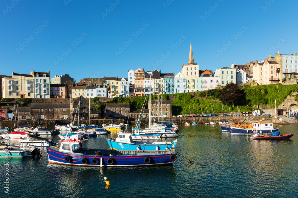 View of the town centre and fishing boats in the harbour, Tenby, Pembrokeshire, Wales