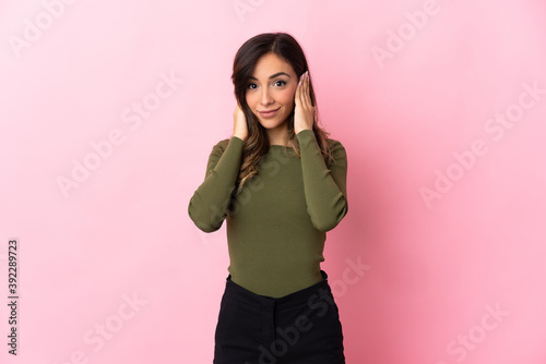 Fototapeta Naklejka Na Ścianę i Meble -  Young caucasian woman isolated on pink background frustrated and covering ears