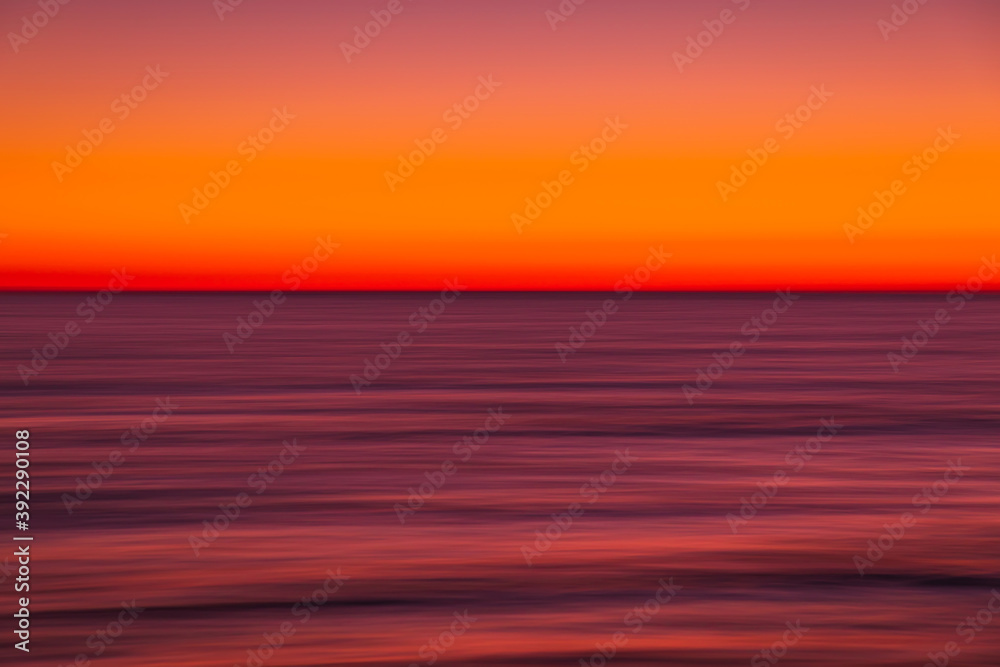 Ocean with waves at bright sunset or sunrise shooting with exposure
