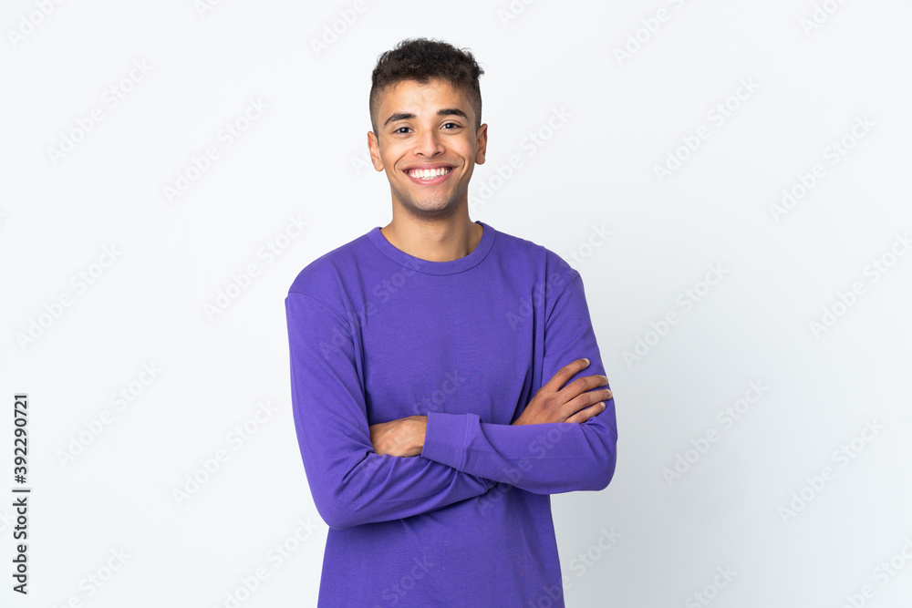 Young brazilian man isolated on white background keeping the arms crossed in frontal position Young brazilian man isolated on white background keeping the arms crossed in frontal position