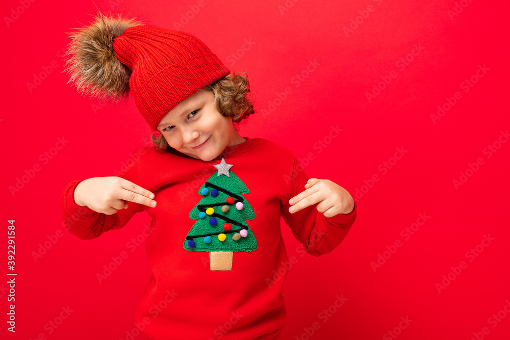 emotional portrait of a teenager on a red background in a new year costume